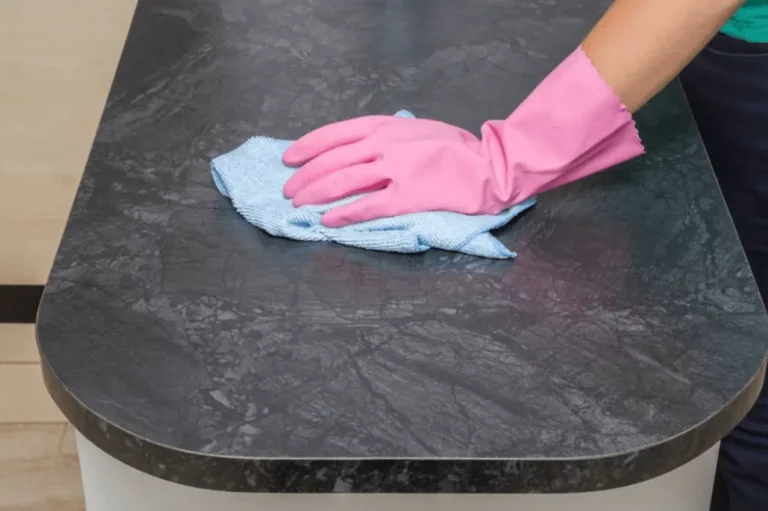 a person cleaning the marble coffee table