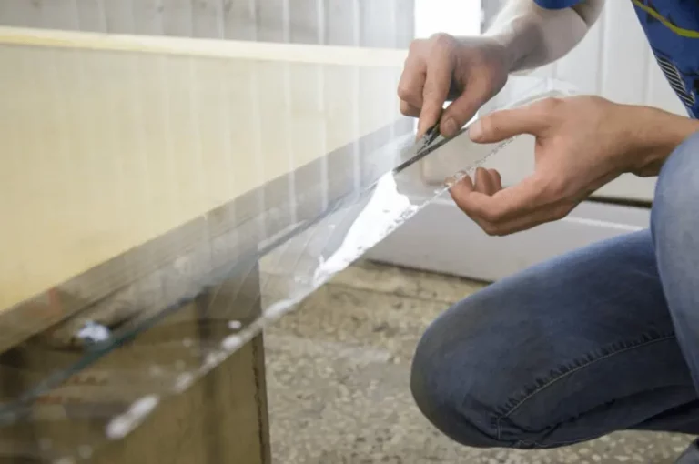 A person remove glue from glass