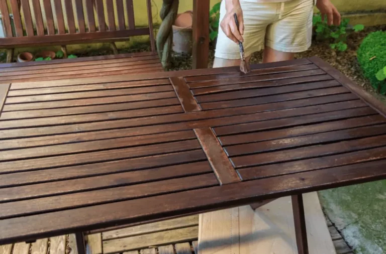 a man restore the shine of wood coffee table